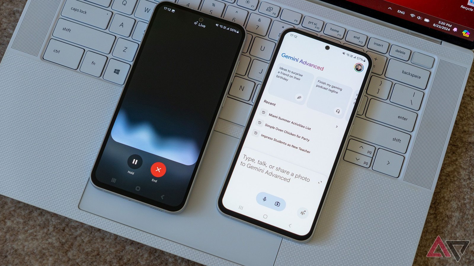two phones running google gemini app and gemini live on a laptop keyboard